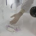 A pharmacist passes syringes from a clean room into the main pharmacy, Wednesday, Dec. 9, 2020 at Mount Sinai Queens hospital in New York.