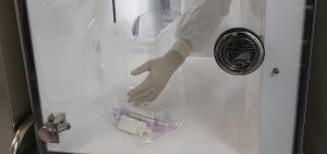 A pharmacist passes syringes from a clean room into the main pharmacy, Wednesday, Dec. 9, 2020 at Mount Sinai Queens hospital in New York.