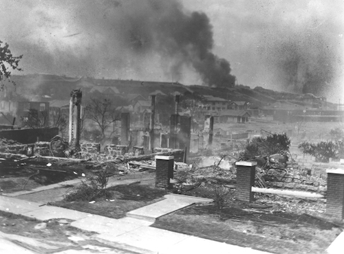 Smoldering ruins of homes in Black neighborhood following the racially motivated massacre in Tulsa, Oklahoma, in 1921.