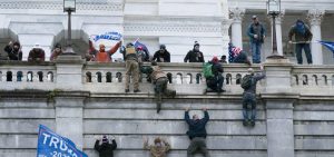 Supporters of President Trump climb the west wall of the U.S. Capitol on Wednesday.