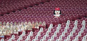 A Cincinnati Reds mascots sits in empty stands during a baseball game against the St. Louis Cardinals at the Great American Ballpark, in Cincinnati, Tuesday, Sept. 1, 2020