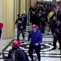 In this image taken from video footage released in a criminal complaint by the U.S. District Court for the District of Columbia, Alexander Sheppard, center, joins other rioters who stormed the U.S. Capitol on Jan. 6, 2021, in Washington.