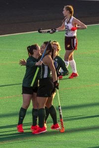 Jillian Shive (18), Leah Warren (21) and Sienna Sakich (6) celebrate after OHIO’s first goal against Central Michigan. (Evann Figueroa/WOUB)