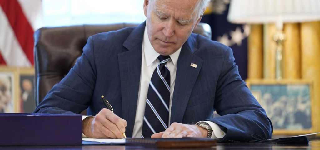 President Joe Biden signs the American Rescue Plan, a coronavirus relief package, in the Oval Office of the White House, Thursday, March 11, 2021, in Washington.
