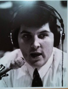 Bob Stolz in front of a radio microphone