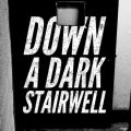 the words "Down a dark stairwell" imposed on a dark stairwell