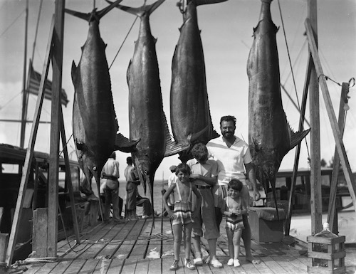 Ernest Hemingway and his three sons (L-R: Patrick, Jack, and Gregory) on the Bimini docks. July 20, 1935.