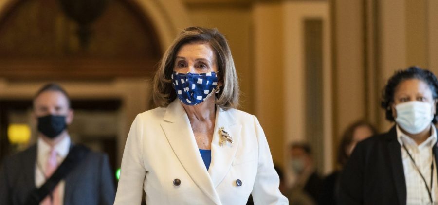 House Speaker Nancy Pelosi of California walks from the House floor during the vote on the $1.9 trillion COVID-19 relief bill Wednesday. Despite Republican criticism, Pelosi insists the bill is "coronavirus-centric."