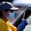 A worker prepares to give a COVID-19 vaccine at the Dignity Health Sports Park in Carson, Calif. on March 18, 2021.