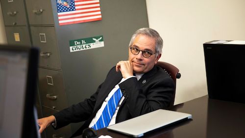 Philadelphia District Attorney, Larry Krasner, at desk.
