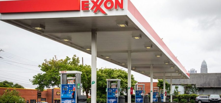 Pictured are pumps at an Exxon gas station in Charlotte, N.C. A tiny fund got two board members elected to the oil giant's board, delivering a historic defeat to ExxonMobil.