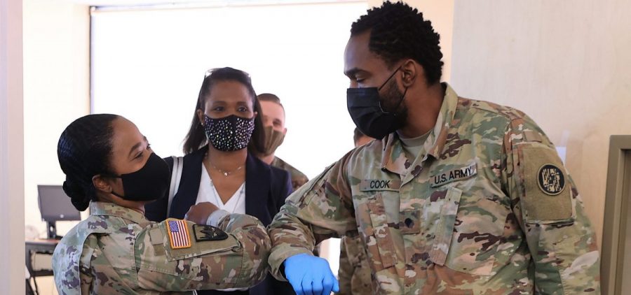 Nearly 130 million U.S. adults have completed their vaccine regimens, the CDC says, with another 70 million vaccine doses currently in the distribution pipeline. Here, Maryland National Guard Brig. Gen. Janeen Birckhead greets soldiers last week at a mobile vaccine clinic in Wheaton, Md.