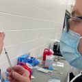 A technician from the Findlay College of Pharmacy fills a syringe with a dose of the Pfizer vaccine at a clinic in Reynoldsburg, February 2021.