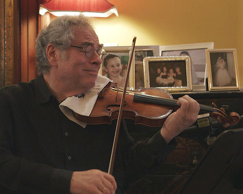 Itzhak Perlman playing violin in office