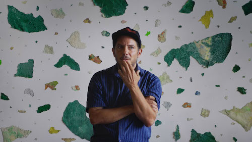 Chemi Rosado-Seijo in front of his large canvas piece, El Cerro.