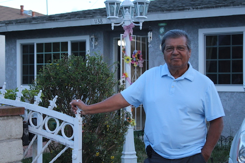 Edwin Siguenza stands in front of his home in Torrence, California.