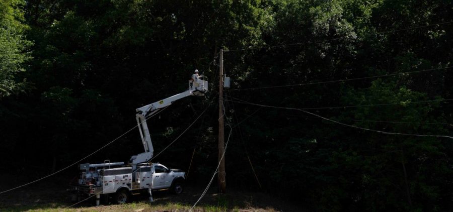 American Electrical Power employees work on restoring power at the scene of a power outage