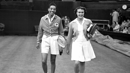Althea Gibson walkig with female on tennis court