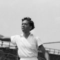 Althea Gibson with tennis racket in air