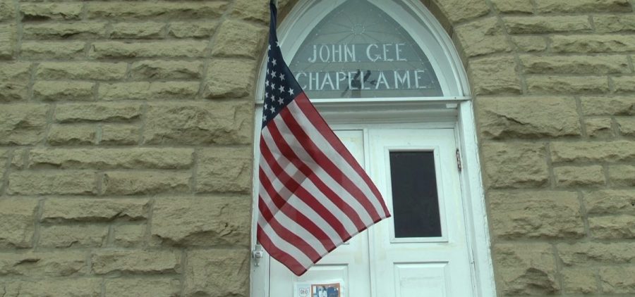 Front of the John Gee Black Historical Center building with American Flag blowing in front of it.