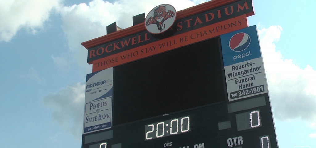 Scoreboard at Rockwell Stadium, which reads "Those who stay will be champions"