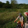 Meredith Erlewine, right, and Joe Crowley, both instructors with the Athens Co. Cougarbats Mountain Bike Team, ride through the beginning portions of the Baileys Trail System, in Chauncey, Ohio, on Saturday, Aug. 7, 2021.