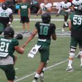 Ohio fifth year senior quarterback Armani Rogers stretches his legs prior to Ohio's first fall scrimmage on Aug. 14, 2021 [Jack Demmler | WOUB]