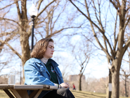 Teen sitting at picnic table in park