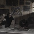 painter working on art on floor of rustic cabin