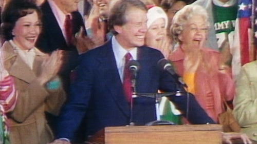 JIMMY CARTER WINS PRESIDENCY OF THE UNITED STATES OF AMERICA standing at podium