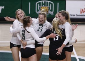 Maggie Denoma embraces her teammates after a point is earned against Eastern Michigan University on October 8, 2021.