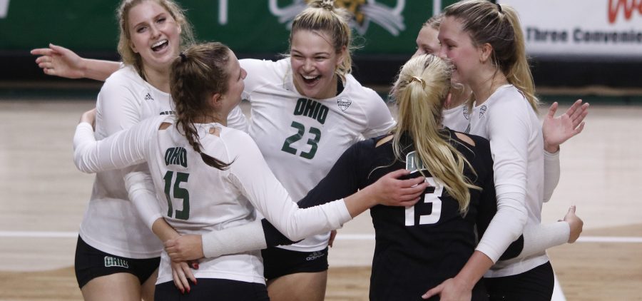 Maggie Denoma embraces her teammates after a point is earned against Eastern Michigan University on October 8, 2021.