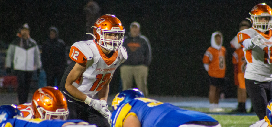 Meadowbrook player stands attentively awaiting the snap