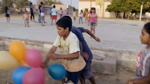 kids chasing ballons