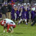 Trimble player crouches on field after defeat