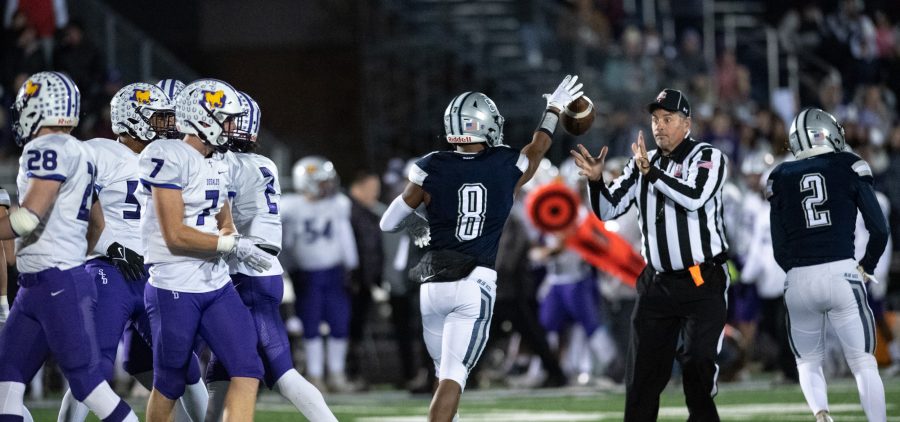 Devon Haley, number 8, of the Granville Blue Aces, tosses the football to a referee during the Blue Aces high school football playoff game against the St. Francis DeSales Stallions, in Granville, Ohio, on Friday, Nov. 5, 2021. The Blue Aces went on to win 19-12.