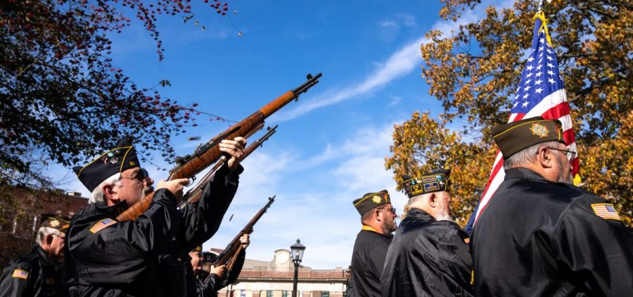 Members of the Albany and Athens Honor Guard fire an honorary rifle salute during the Veterans Day ceremony in Athens, Ohio, on Thursday, Nov. 11, 2021.