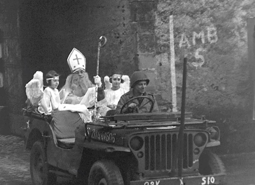 1940 St. Nick riding into town in a military jeep