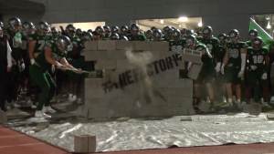 Eastern Michigan players bust down the cinderblock wall before entering the field for their game against Ohio on Nov. 9, 2021.