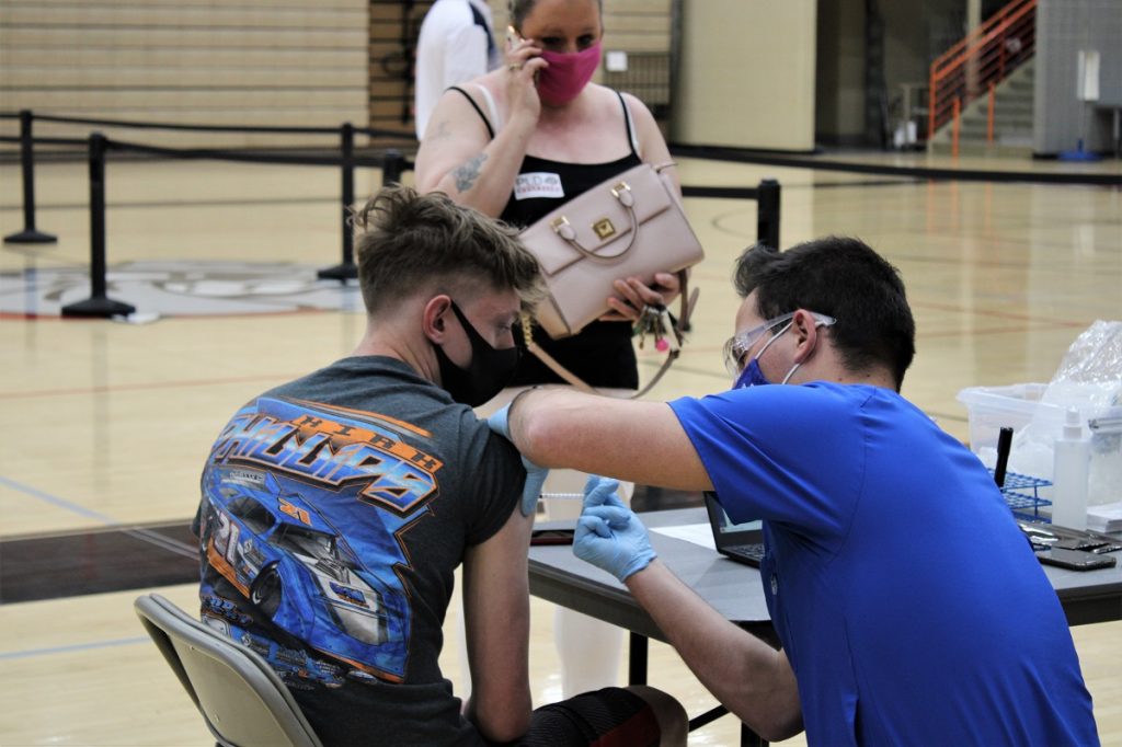 A student gets a vaccine at A vaccine clinic at Paul Laurence Dunbar High School in Kentucky