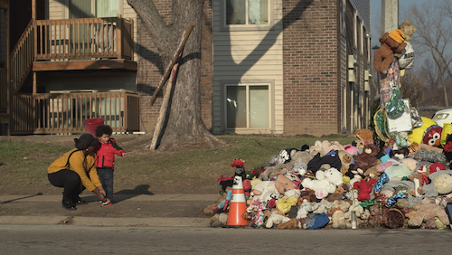 Mother and child looking at Michael Brown Jr.’s memorial site