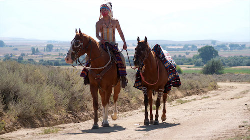 Natuve American Araoho on horseback leading riderless horse