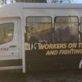 A passenger van is decorated with messages of solidarity for striking workers