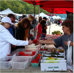 Vendors serve customers at Athens Farmer's Market on East. State. St. 