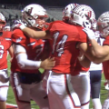 Jackson players excitedly huddle after touchdown