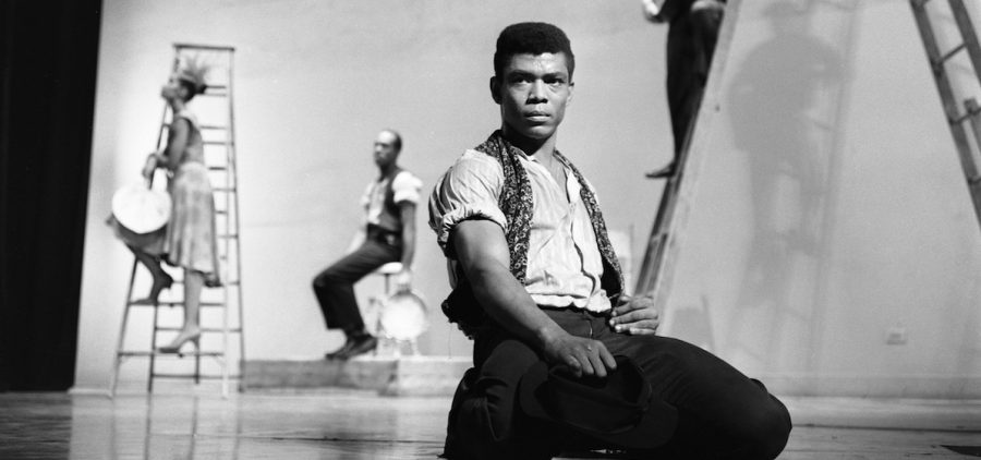 Alvin Ailey on his knees on stage with glowering look in eyes