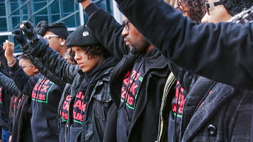 Black Power protest. Peopplem dressed the same with fists raised.