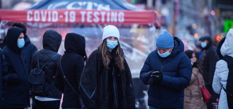 People wait at a street-side testing booth in New York's Times Square on Monday.