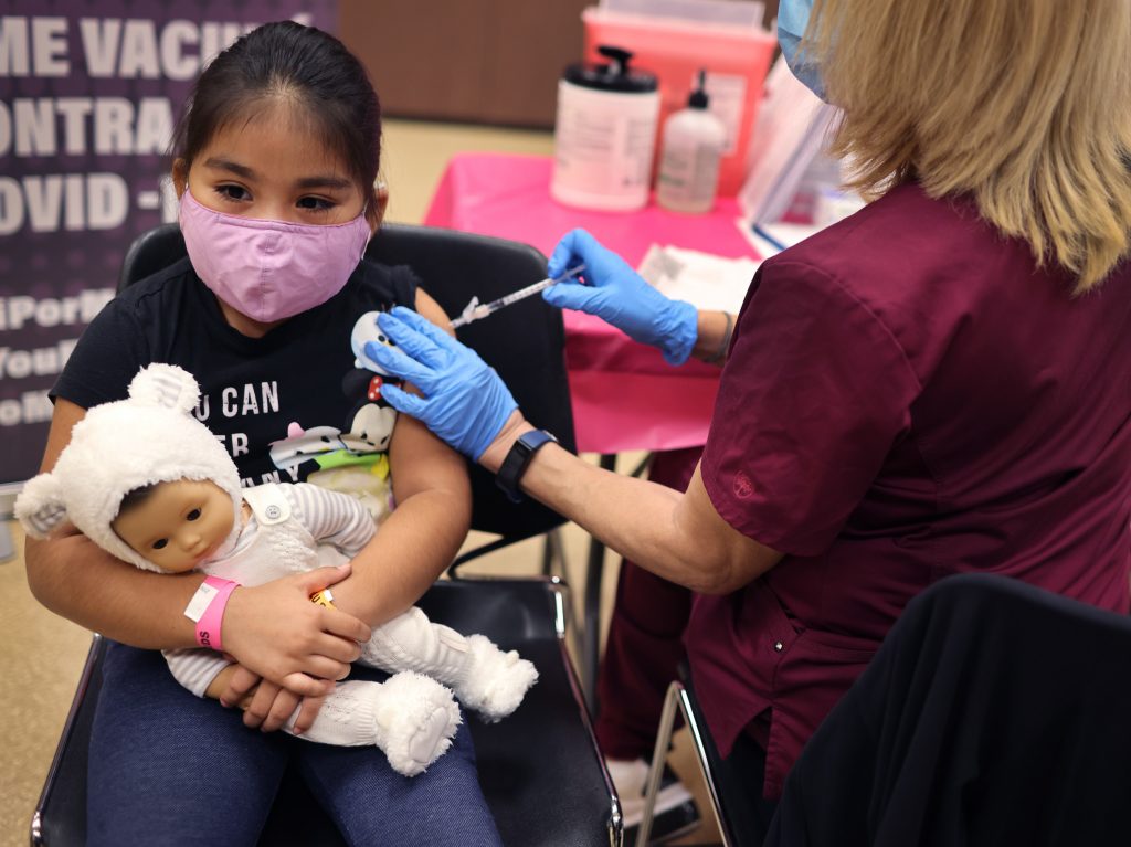 Seven-year-old Rihanna Chihuaque receives a COVID-19 vaccine in Chicago