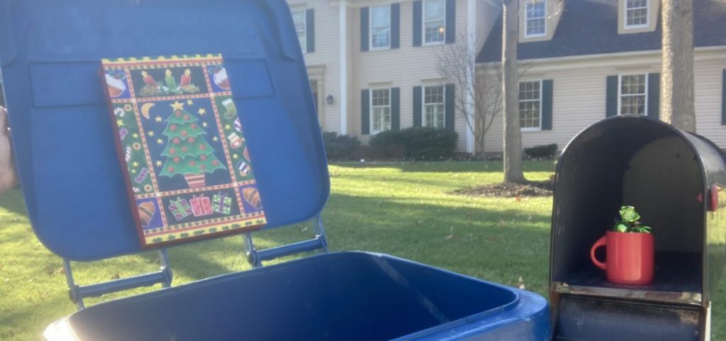 Gifts on a trash can lid and an open mailbox